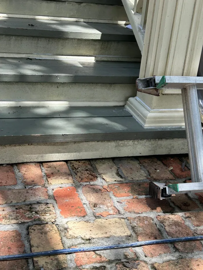 AA Home Remodeling crew painting a stucco home exterior in Houston