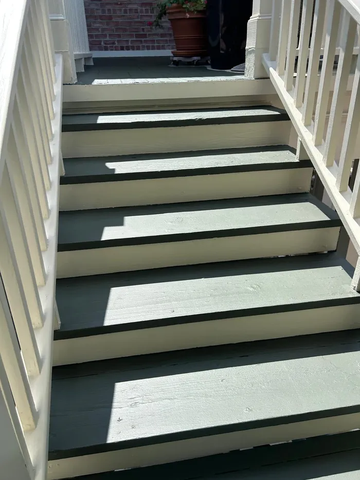 Freshly painted porch stairs in green and cream tones